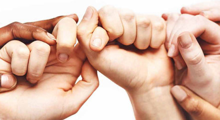 Image of six hands touching